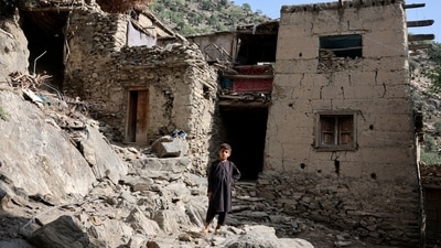 A boy stands in front of houses damaged by a deadly earthquake that struck Afghanistan's Kunar and Nangarhar provinces, at Masud village in Nurgal district, Kunar province, Afghanistan. (REUTERS File)
