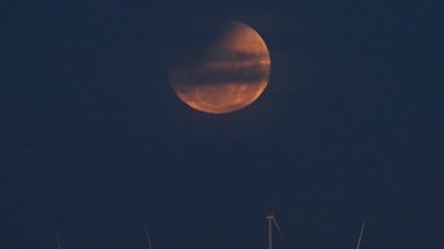 The blood moon happens when Earth’s shadow fully covers the moon, making it look deep red or orange. (Photo by Izhar KHAN / AFP) (AFP) The blood moon happens when Earth’s shadow fully covers the moon, making it look deep red or orange. (Photo by Izhar KHAN / AFP) (AFP)