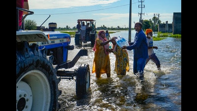 Water bottles being distributed among flood-affected people at Talwandi Rai Dadu village in Amritsar on Friday. (PTI) Water bottles being distributed among flood-affected people at Talwandi Rai Dadu village in Amritsar on Friday. (PTI)