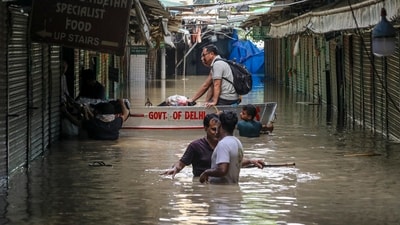 People use a boat through a flooded Monastery Market as the Yamuna River flooded the area in Delhi (PTI) People use a boat through a flooded Monastery Market as the Yamuna River flooded the area in Delhi (PTI)