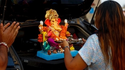 In Gujarat's Ahmedabad, a woman worships an idol of Lord Ganesh before immersion into the Sabarmati river as part of the Ganesh Chaturthi festival celebrations. (PTI) In Gujarat's Ahmedabad, a woman worships an idol of Lord Ganesh before immersion into the Sabarmati river as part of the Ganesh Chaturthi festival celebrations. (PTI)