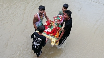 In Punjab's Amritsar, devotees celebrate in the rain as they carry idols of Lord Ganesha for immersion in a canal during the Ganesh Chaturthi festival. (ANI) In Punjab's Amritsar, devotees celebrate in the rain as they carry idols of Lord Ganesha for immersion in a canal during the Ganesh Chaturthi festival. (ANI)