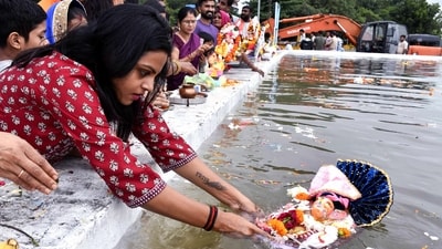 Devotees immerse idols of Lord Ganesha in a pond on the occasion of the Dol Gharas festival in Madhya Pradesh's Bhopal. (PTI) Devotees immerse idols of Lord Ganesha in a pond on the occasion of the Dol Gharas festival in Madhya Pradesh's Bhopal. (PTI)