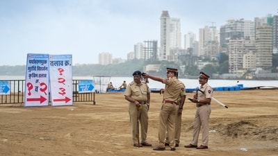 Police personnel keep vigil as part of crowd control measures for the immersion of Lord Ganesh idols as the Ganesh Chaturthi festival concludes, at Girgaon Chowpatty, in Mumbai. (PTI) Police personnel keep vigil as part of crowd control measures for the immersion of Lord Ganesh idols as the Ganesh Chaturthi festival concludes, at Girgaon Chowpatty, in Mumbai. (PTI)