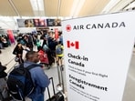 Passengers queue for check-in for their flights at Toronto Pearson International Airport, following the end of the Air Canada labour strike, in Mississauga, Ontario, Canada, August 19, 2025.
