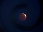 A rare 'blood Moon' total lunar eclipse is captured near totality from the village of Donon, 40 km from Pontevedra, in northwestern Spain, early on March 14, 2025. A rare 'blood Moon' total lunar eclipse is captured near totality from the village of Donon, 40 km from Pontevedra, in northwestern Spain, early on March 14, 2025.