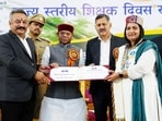 Himachal governor Shiv Pratap Shukla presents state award to a teacher during a ceremony organised on Teachers' Day, at Peter Hoff, in Shimla, on Friday. (ANI)