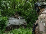 Ukrainian soldiers and an armored vehicle in the Sumy region.