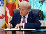 President Donald Trump signs an executive order in the Oval Office of the White House, Friday, Sept. 5, 2025, in Washington.