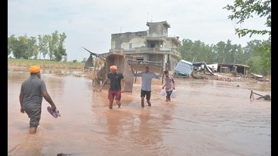 A collapsed house at a flooded village in Ramdas, Amritsar, on Saturday. (Sameer Sehgal/HT)
