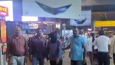 The accused arrested in bomb threat case is being brought to Mumbai from Noida. (ANI screen grab) The accused arrested in bomb threat case is being brought to Mumbai from Noida. (ANI screen grab)