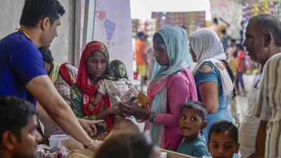 People queue to receive aid distributed by civic authorities at a makeshift relief camp in Mayur Vihar on Saturday. Officials and residents alike fear that health risks will worsen once floodwaters subside. (RAJ K RAJ /HT PHOTO) People queue to receive aid distributed by civic authorities at a makeshift relief camp in Mayur Vihar on Saturday. Officials and residents alike fear that health risks will worsen once floodwaters subside. (RAJ K RAJ /HT PHOTO)