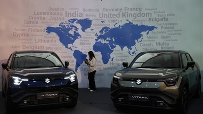 A visitor uses her phone next to Maruti Suzuki's e Vitara SUV at the company's Gujarat plant in the village of Hansalpur Becharaji, India, August 26, 2025. REUTERS/Amit Dave (REUTERS)