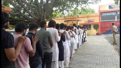 The arrested youths in queue outside the district jail in Firozabad on Saturday. (HT)