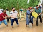 Deputy commissioner Himanshu Jain (second from right) with local residents, placing sandbags on the banks of Sutlej river in Sasrali Colony in Ludhiana on Saturday. (HT Photo) Deputy commissioner Himanshu Jain (second from right) with local residents, placing sandbags on the banks of Sutlej river in Sasrali Colony in Ludhiana on Saturday. (HT Photo)