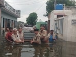 Police and locals rescuing an elderly in Bhiwani’s Sagwan village on Saturday. (HT Photo) Police and locals rescuing an elderly in Bhiwani’s Sagwan village on Saturday. (HT Photo)