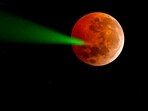 The full moon eclipse is targeted with a laser from the Foster Observatory telescope in Santiago, Chile, on March 14, 2025. The full moon eclipse is targeted with a laser from the Foster Observatory telescope in Santiago, Chile, on March 14, 2025.