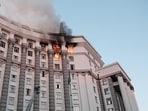 Firefighters work at the site of a headquarters building of the Ukrainian government damaged during Russian drone and missile strikes.