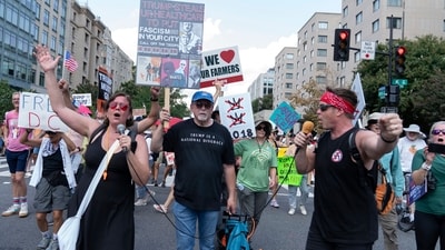 Demonstrators chant slogans with a mic to protest against President Donald Trump's deployment of federal law enforcement and National Guard troops in Washington&nbsp; (AP)