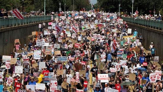 Thousands of people marched in solidarity with posters and signboards calling out the Trump administration for the deployment of National Guard troops in Washington, DC.(AFP)