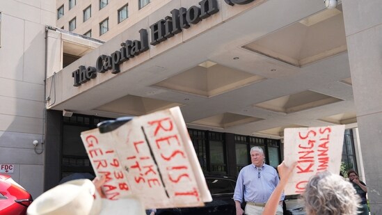 A man stands at a Hilton hotel, as demonstrators attend the "We Are All DC" march to protest against National Guard troops in Washington, D.C.(Reuters)
