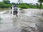 A man commutes through waterlogged areas after several canals overflow due to incessant rainfall, in Dausa. A man commutes through waterlogged areas after several canals overflow due to incessant rainfall, in Dausa.