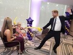 Prince Harry, Duke of Sussex (R) plays with modelling balloons with nine-year-old Gwen Foster (C), recipient of the Inspirational Child 7-11 award,speaks with six-year-old Esmee Mcglinchey (C), at the annual WellChild Awards in London on September 8, 2025.