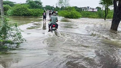 A man commutes through waterlogged areas after several canals overflow due to incessant rainfall, in Dausa. (ANI Video Grab) A man commutes through waterlogged areas after several canals overflow due to incessant rainfall, in Dausa. (ANI Video Grab)