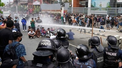 Riot police used water cannon to disperse the protestors outside the parliament building in Kathmandu, Nepal, on Monday. (AP) Riot police used water cannon to disperse the protestors outside the parliament building in Kathmandu, Nepal, on Monday. (AP)