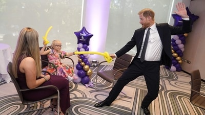 Prince Harry, Duke of Sussex (R) plays with modelling balloons with nine-year-old Gwen Foster (C), recipient of the Inspirational Child 7-11 award,speaks with six-year-old Esmee Mcglinchey (C), at the annual WellChild Awards in London on September 8, 2025. (AFP)