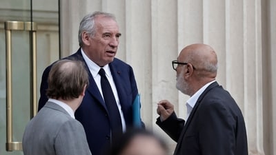 France's Prime Minister Francois Bayrou speaks with French politician of the Democratic Movement (MoDem) Bruno Millienne (R) as he leaves the National Assembly after the result of a confidence vote over the government's austerity budget, at the National Assembly in Paris on September 8, 2025. (AFP)