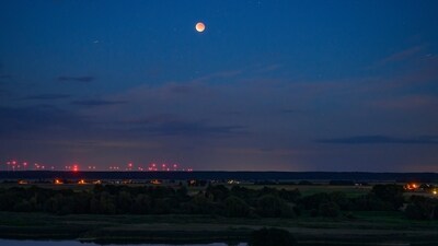 A total lunar eclipse can be seen as a so-called blood moon in the evening sky over the landscape on the German-Polish border river Oder, in Lebus, Germany. (AP)