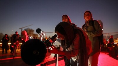 People gather to watch the "Blood Moon" total lunar eclipse in Tehran, Iran. (via REUTERS)
