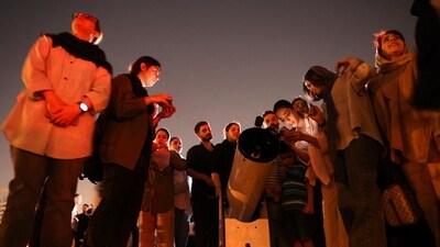 People gather to watch the "Blood Moon" total lunar eclipse in Tehran, Iran. (via REUTERS)
