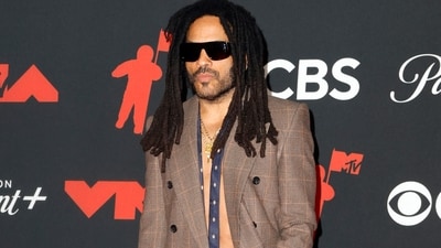 Lenny Kravitz was a smoke-show dressed in a Saint Laurent tweed suit, his bare chest being grazed by a loose blue tie with white polka dots and a statement gold chain necklace. He bagged the award for Best Rock Video. (REUTERS)