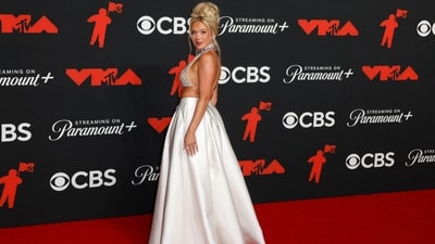 Country musician Megan Moroney looked radiantly elegant in an embellished backless halter top and satin maxi skirt. She bagged the Moon Man for Best Country Award at the ceremony. (REUTERS)