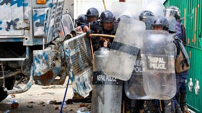 Visuals showed riot police personnel taking shelter behind a security vehicle as demonstrators pelted stones during the protest, demanding the government lift its ban on social media and tackle corruption (AFP) Visuals showed riot police personnel taking shelter behind a security vehicle as demonstrators pelted stones during the protest, demanding the government lift its ban on social media and tackle corruption (AFP)