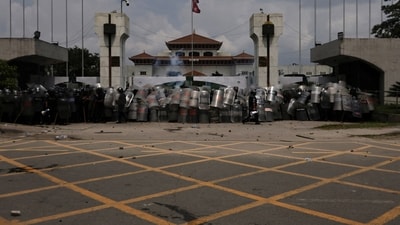 Police officers geared up to guard the entrance of the Parliament during a protest against corruption and the government’s decision to block several social media platforms, in Kathmandu, Nepal (Reuters)