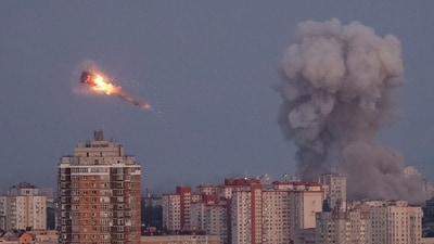 Ukrainian servicemen shoot down a Russian missile as smoke rises from the city during a Russian missile strike, amid Russia's attack on Ukraine, in Kyiv. (REUTERS)