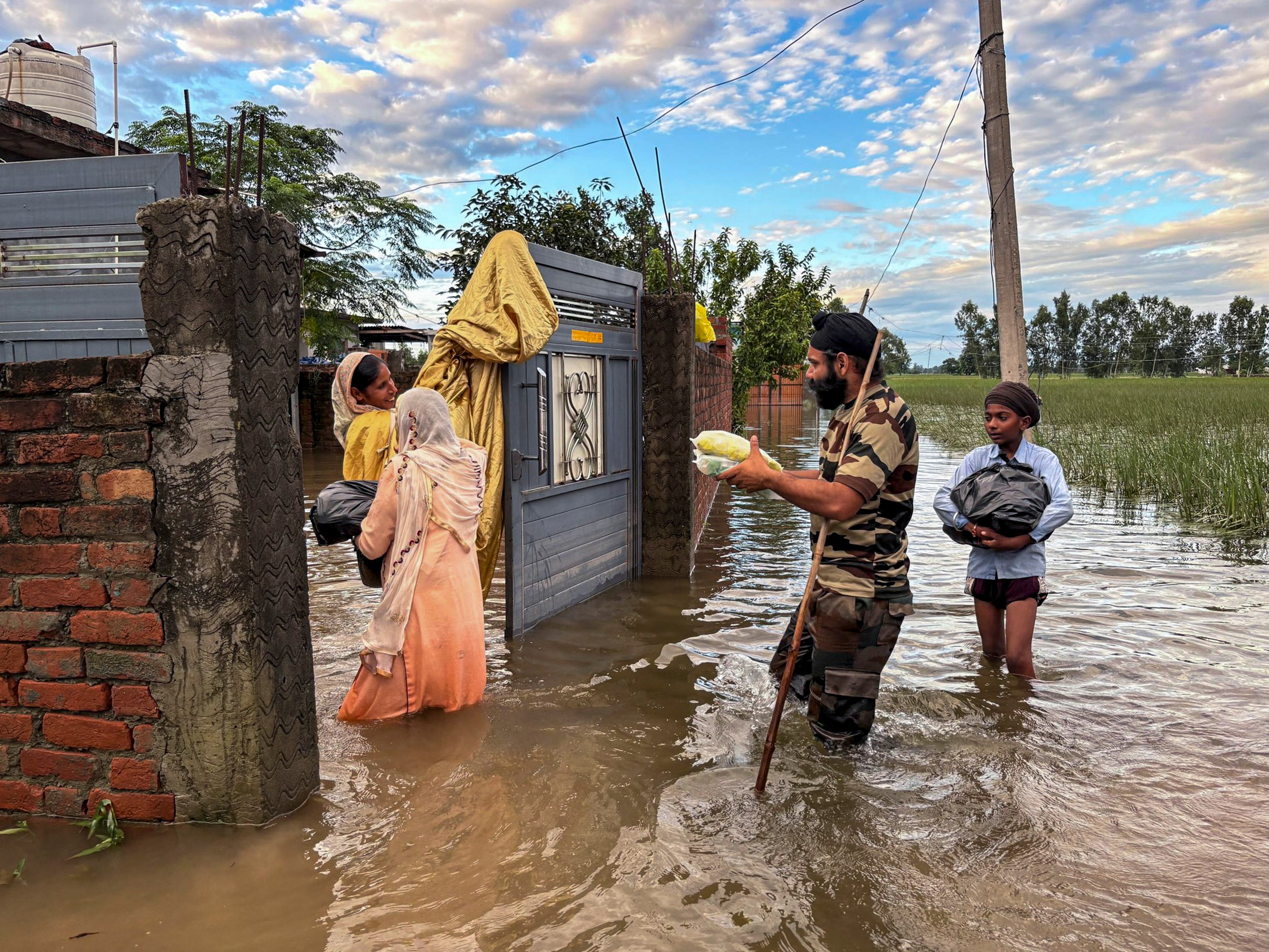 An army personnel distributing relief material in a flood-affected area in Punjab. (X/@VajraCorps_IA) An army personnel distributing relief material in a flood-affected area in Punjab. (X/@VajraCorps_IA)