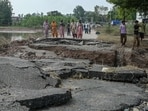 Villagers stand near a damaged road after a rise in the water level of the Ravi River following heavy monsoon rains in the Ghonewala village near Punjab's Amritsar 