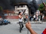 Demonstrators carrying weapons, taken from the supreme court, take part in a protest against Monday's killing of 19 people after anti-corruption protests that were triggered by a social media ban, outside the supreme court in Kathmandu