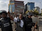 A demonstrator reacts as he is detained by police officers outside the Parliament during a curfew following a protest against corruption and government’s decision to block several social media platforms, in Kathmandu.