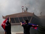 Demonstrators hold flags at the Parliament complex in Nepal during a protest on September 9, 2025.