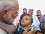Prime Minister Narendra Modi with a child survivor during a meeting with flood-affected people of Kangra in Himachal Pradesh on Tuesday. (PTI Photo) Prime Minister Narendra Modi with a child survivor during a meeting with flood-affected people of Kangra in Himachal Pradesh on Tuesday. (PTI Photo)