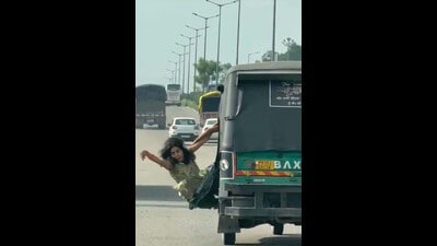 A screen grab of the woman hanging from the moving auto on the Jalandhar bypass on Tuesday. (HT Photo) A screen grab of the woman hanging from the moving auto on the Jalandhar bypass on Tuesday. (HT Photo)
