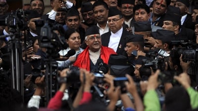 Nepal's newly-elected Prime Minister KP Sharma Oli (C) speaks to the media as he leaves the parliament in Kathmandu. (Photo by Prakash MATHEMA / AFP) (AFP)