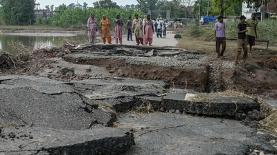 Villagers stand near a damaged road after a rise in the water level of the Ravi River following heavy monsoon rains in the Ghonewala village near Punjab's Amritsar (AFP) Villagers stand near a damaged road after a rise in the water level of the Ravi River following heavy monsoon rains in the Ghonewala village near Punjab's Amritsar (AFP)