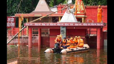 NDRF personnel amid a search and rescue operation at an area inundated with floodwater of the swollen Ganga , in Varanasi, on Tuesday. (PTI) NDRF personnel amid a search and rescue operation at an area inundated with floodwater of the swollen Ganga , in Varanasi, on Tuesday. (PTI)