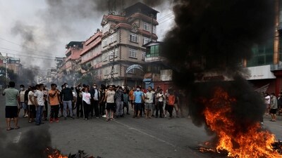 Demonstrators shout slogans as they gather to protest against Monday's killing of 19 people after anti-corruption protests that were triggered by a social media ban which was later lifted, during a curfew in Kathmandu, Nepal, September 9, 2025. (REUTERS)